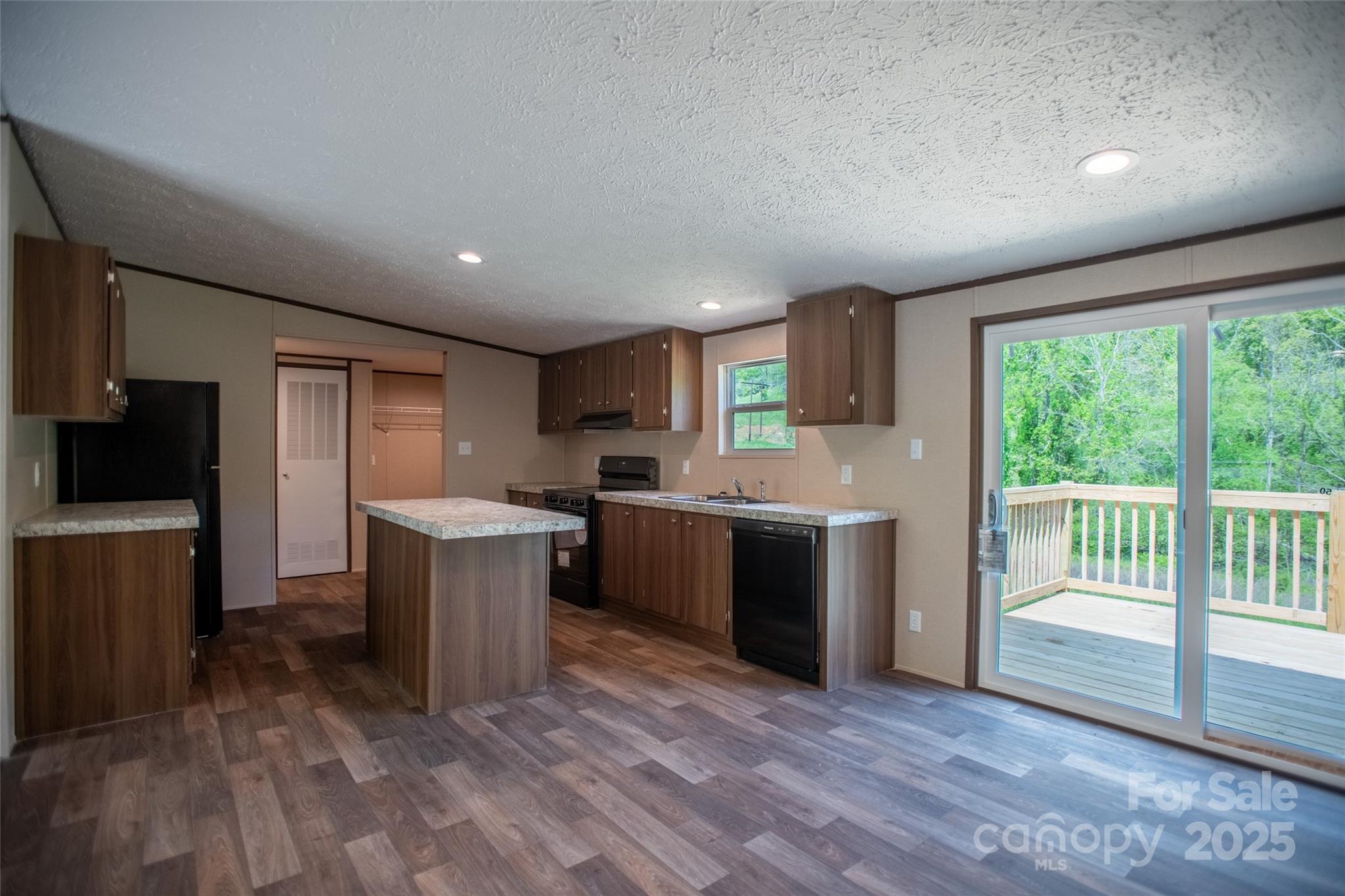 1455 Newfound Road Leicester, NC 28748 - Photo 9 of 47 a kitchen with a refrigerator and a sink