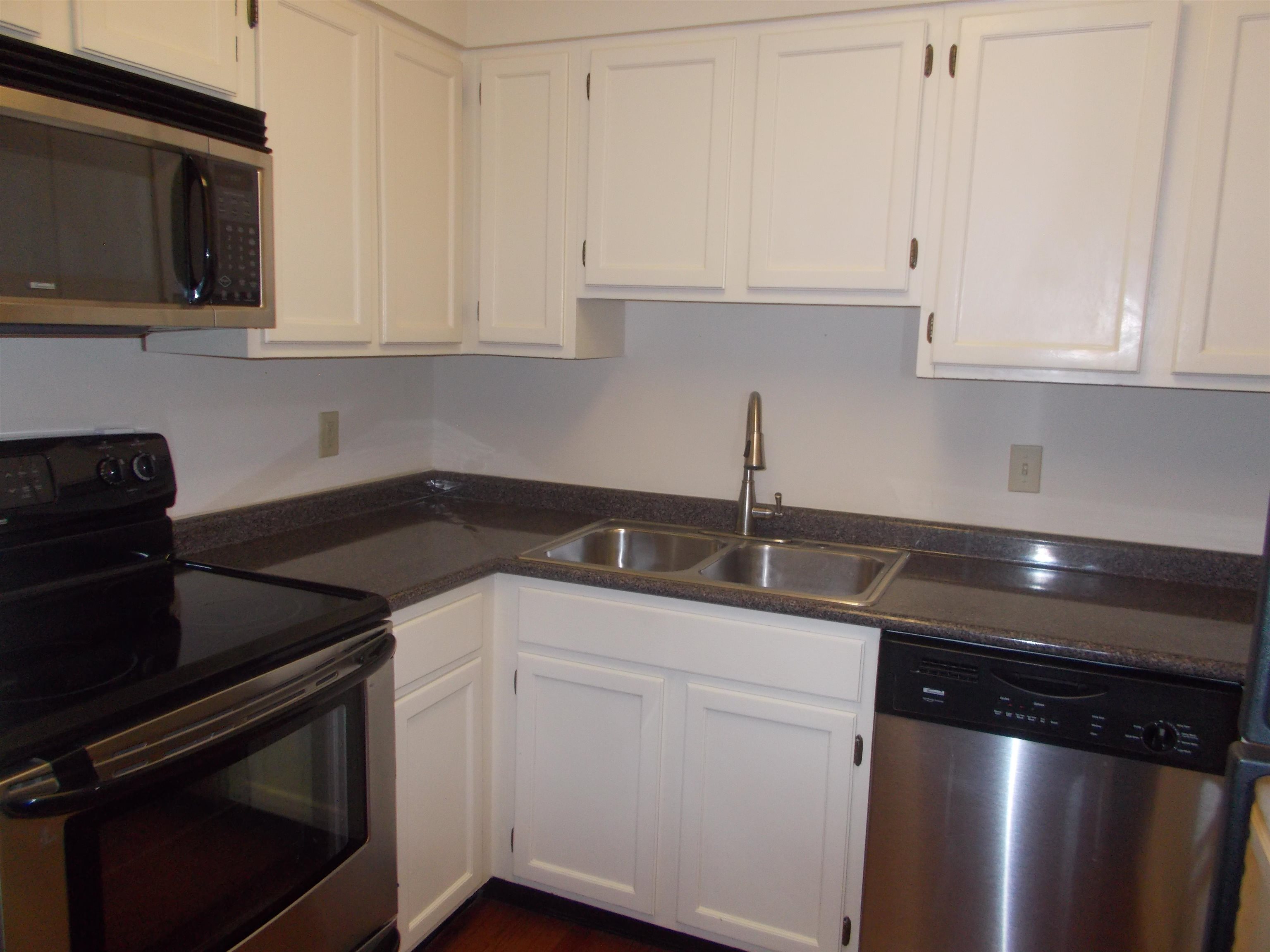 109 North Main Street, Unit 1207 Memphis, TN 38103 - Photo 7 of 25 Kitchen with stainless steel appliances and white cabinetry