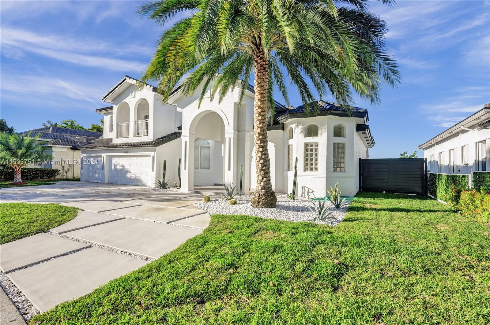18831 Southwest 24th Street Miramar, FL 33029 - Photo 15 of 96 a front view of a house with garden