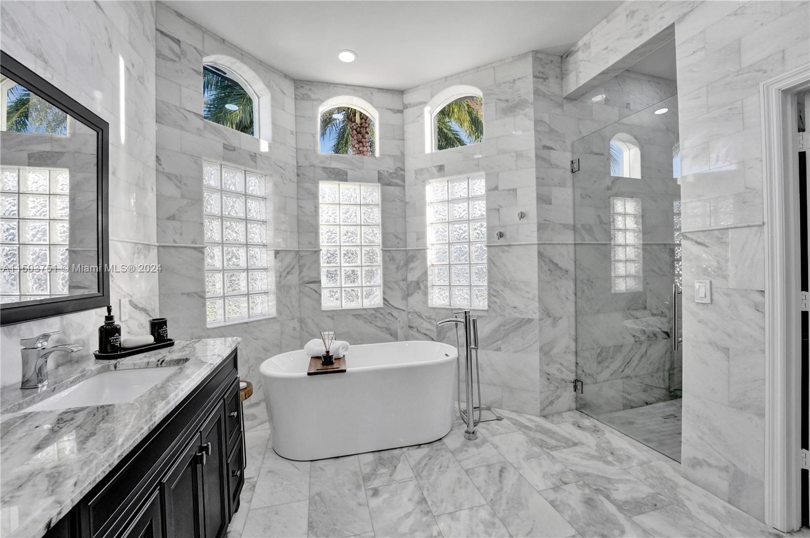 18831 Southwest 24th Street Miramar, FL 33029 - Photo 36 of 96 a bathroom with a granite countertop sink mirror and shower
