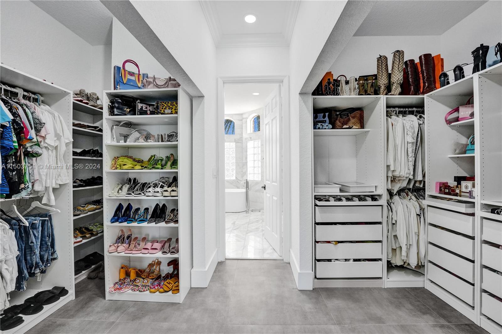 18831 Southwest 24th Street Miramar, FL 33029 - Photo 38 of 96 a view of walk in closet with clothes and shoes