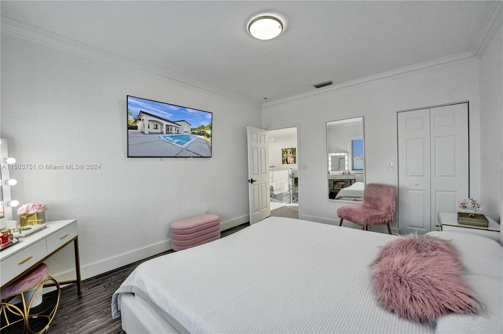 18831 Southwest 24th Street Miramar, FL 33029 - Photo 61 of 96 a bedroom with a bed and a lamp on dresser
