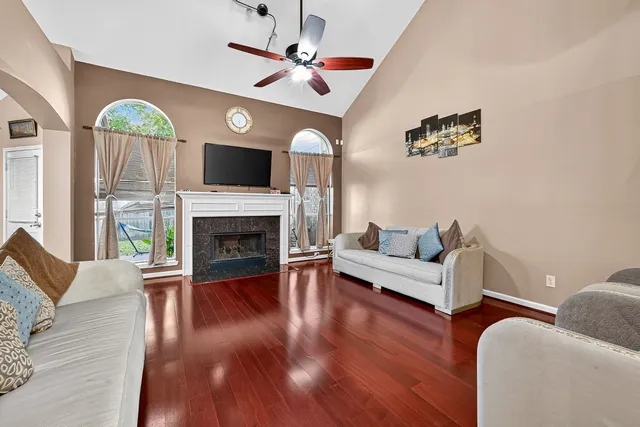 a living room with furniture fireplace and wooden floor
