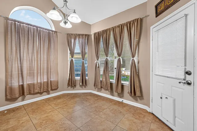 a large kitchen with stainless steel appliances granite countertop a stove a sink dishwasher and a refrigerator