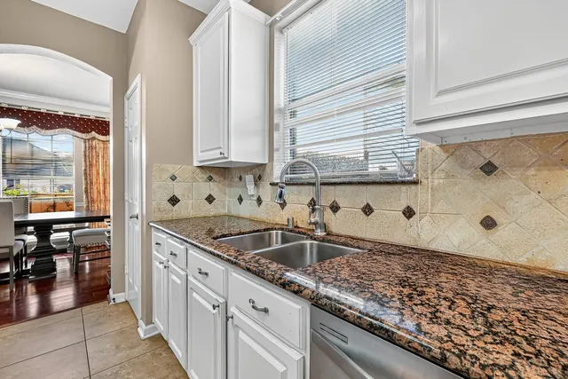 a kitchen with stainless steel appliances granite countertop a stove microwave and cabinets