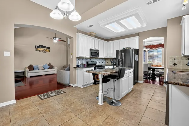 a view of a hallway with dining table and chairs