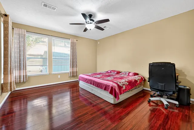 a bedroom with a bed and a chandelier