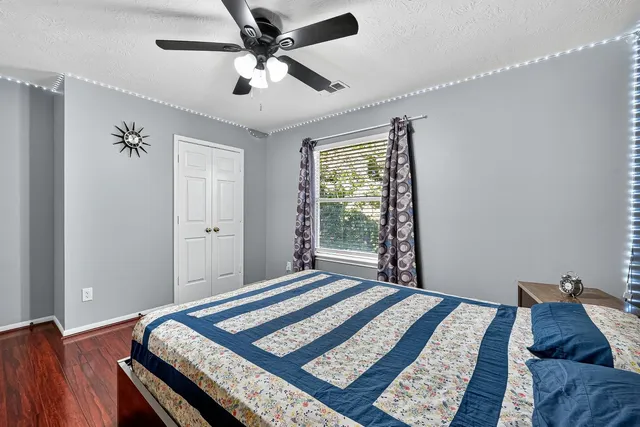 a bedroom with a bed and a tv on the dresser