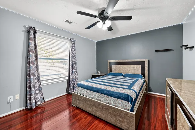 a bed room with a bed and a large window