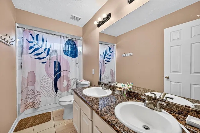a living room with furniture a large window and a chandelier