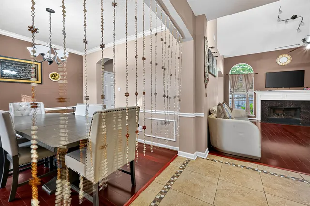 a living room with furniture a fireplace and a chandelier