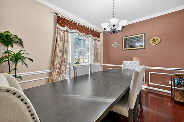 a view of a dining room with furniture and a chandelier