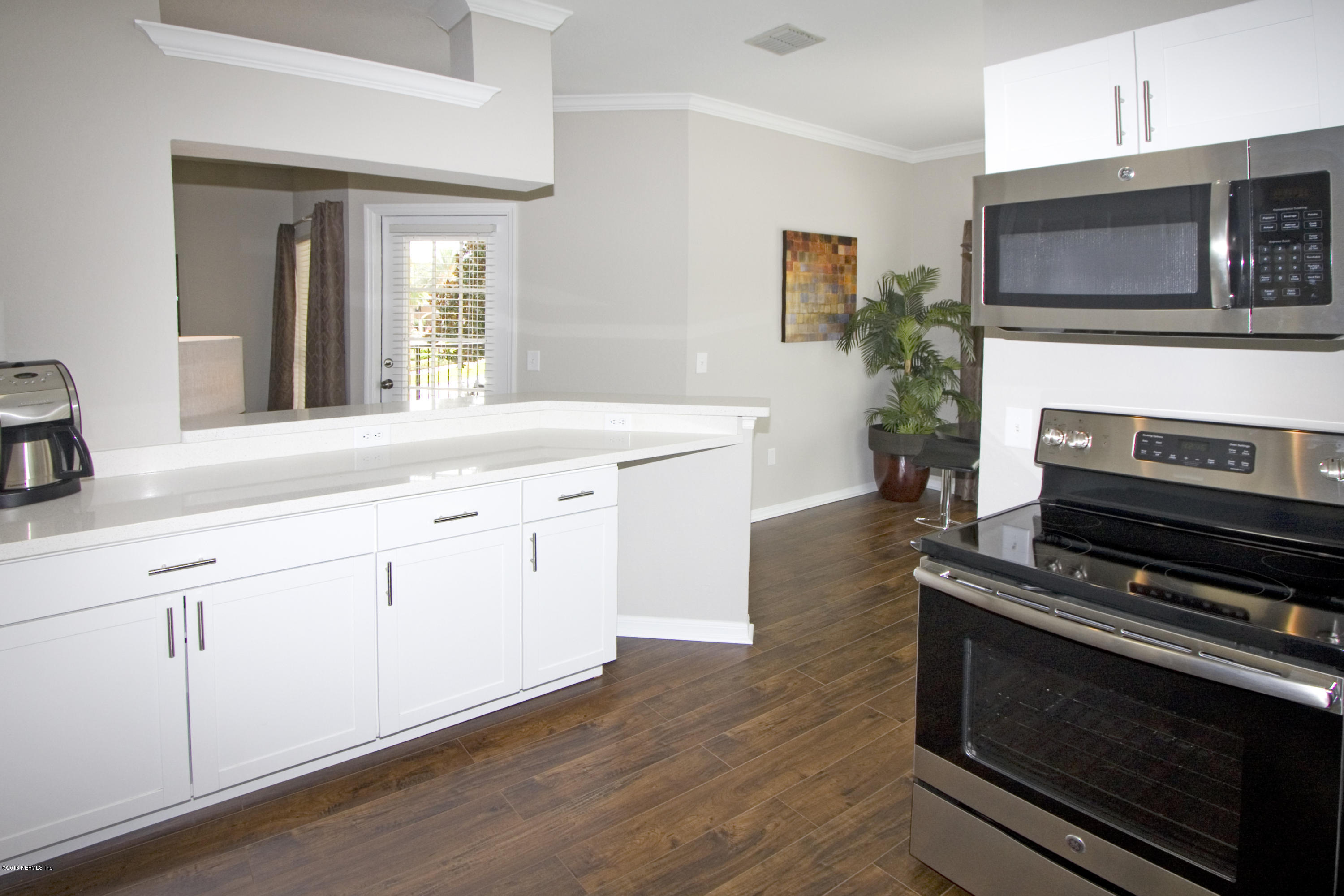 10961 Burnt Mill Road, Unit 222 Jacksonville, FL 32256 - Photo 3 of 20 a kitchen with a stove microwave and cabinets