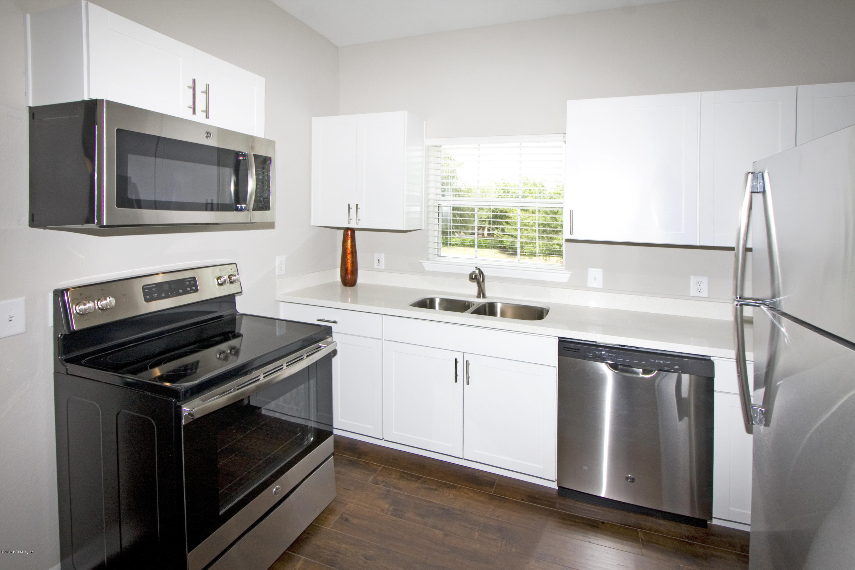 10961 Burnt Mill Road, Unit 222 Jacksonville, FL 32256 - Photo 5 of 20 a kitchen with a stove microwave and sink