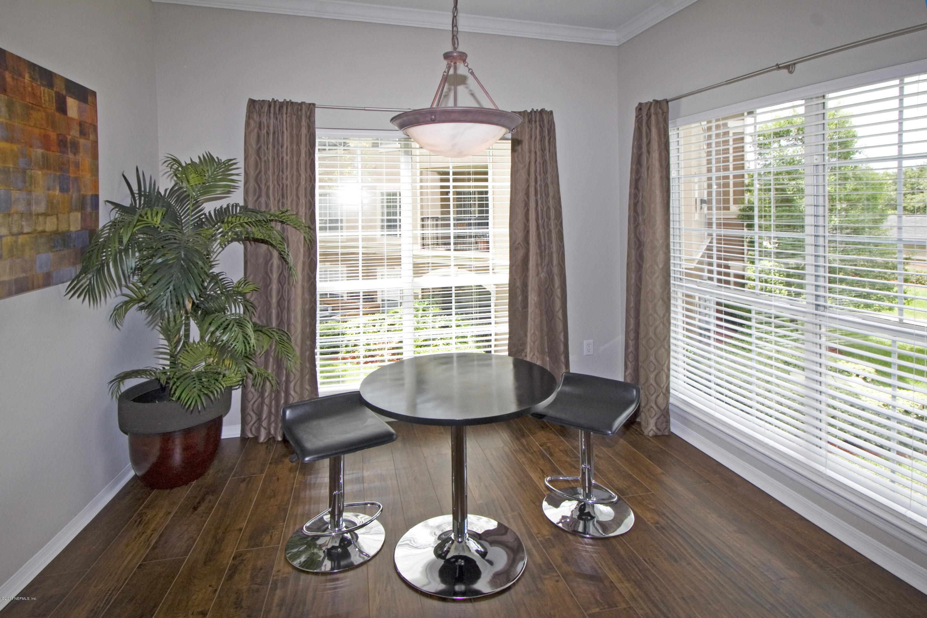 10961 Burnt Mill Road, Unit 222 Jacksonville, FL 32256 - Photo 8 of 20 a living room with furniture and a potted plant