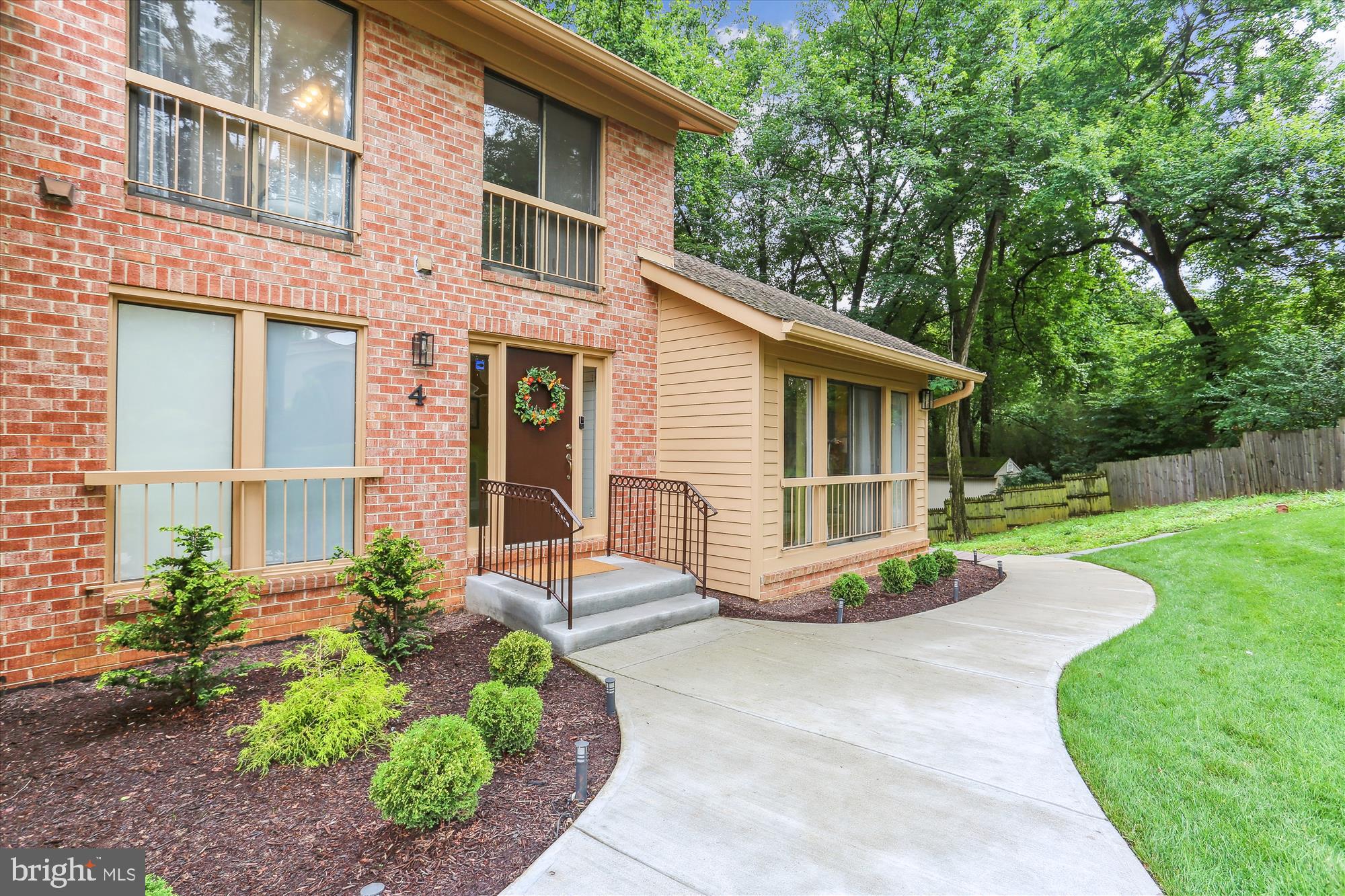 4 Eaglebrook Court Rockville, MD 20854 - Photo 2 of 83 a front view of a house with a yard and potted plants