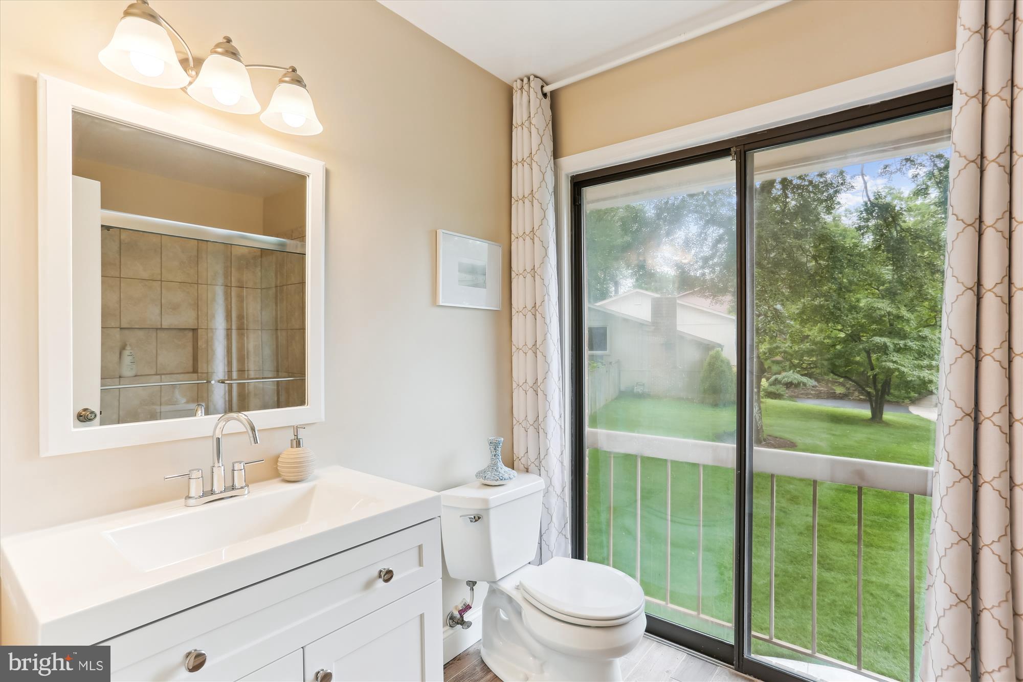 4 Eaglebrook Court Rockville, MD 20854 - Photo 47 of 83 a bathroom with a sink a toilet a mirror and next to a window