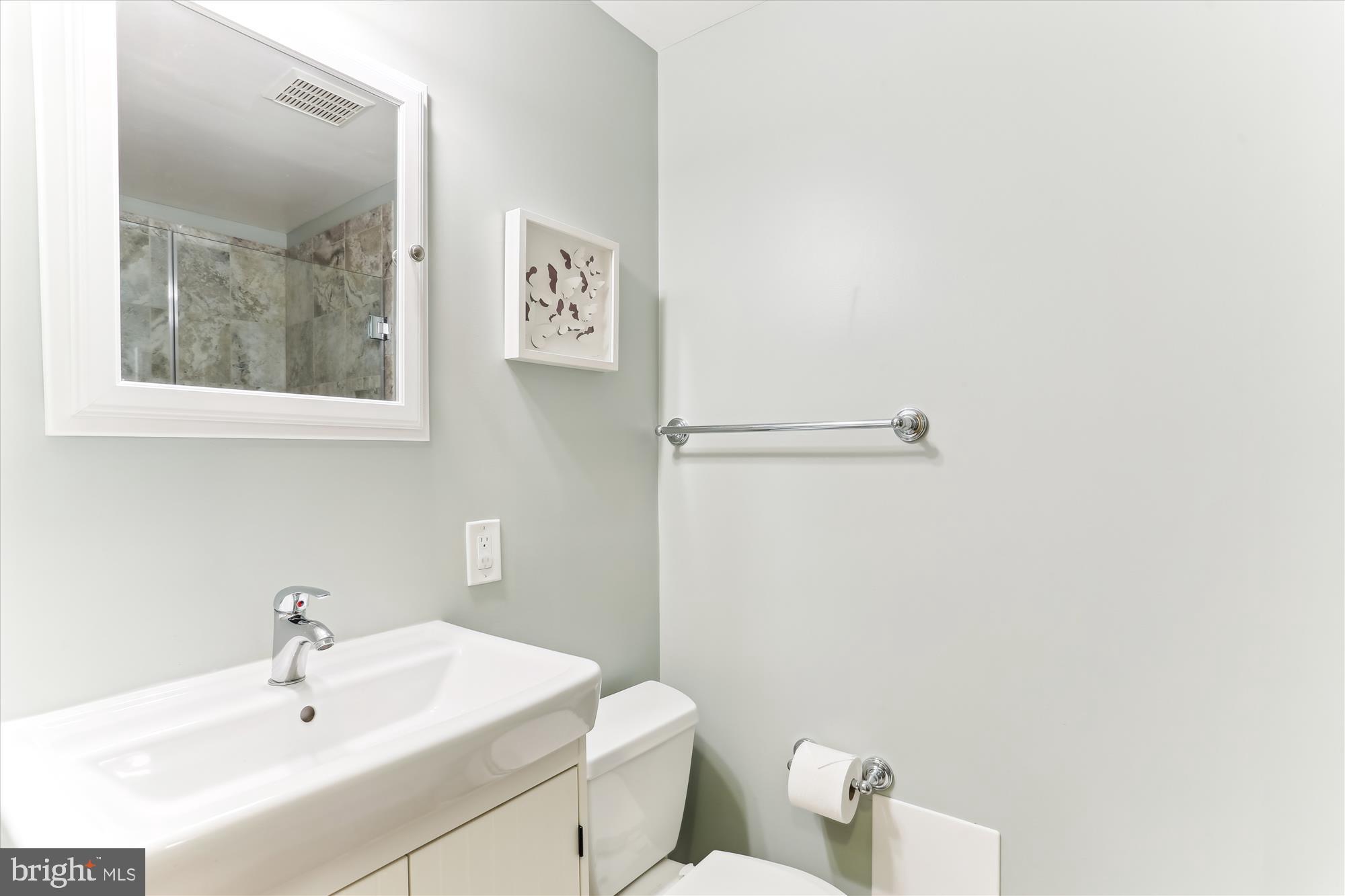 4 Eaglebrook Court Rockville, MD 20854 - Photo 61 of 83 a bathroom with a sink a toilet and mirror