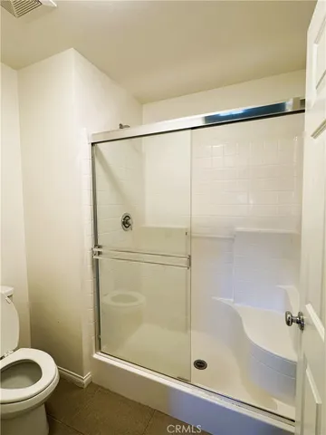a bathroom with a shower and a toilet