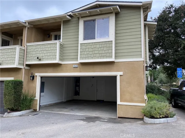 a view of a house with a yard and garage