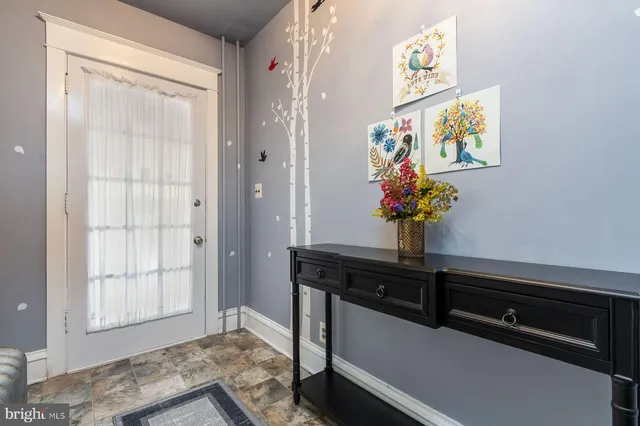a view of a room with wooden floor and windows