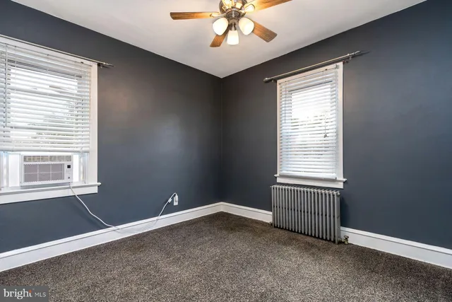 an empty room with closet and mirror