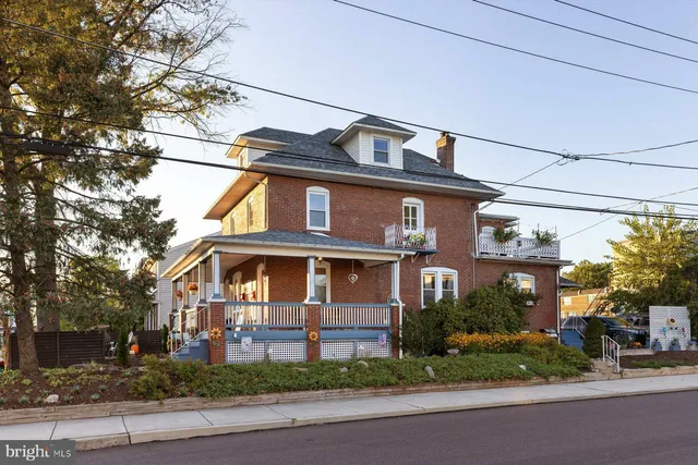a front view of a house with a yard and a garage