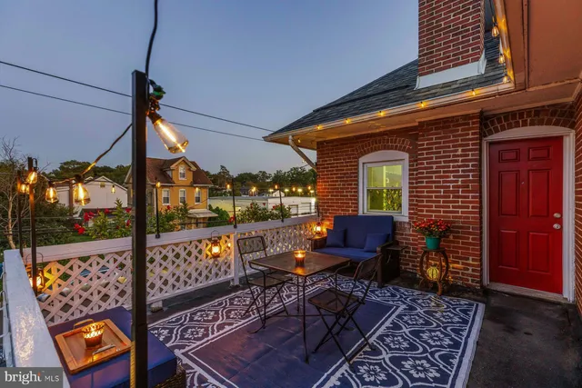 a view of a chairs and table in the balcony