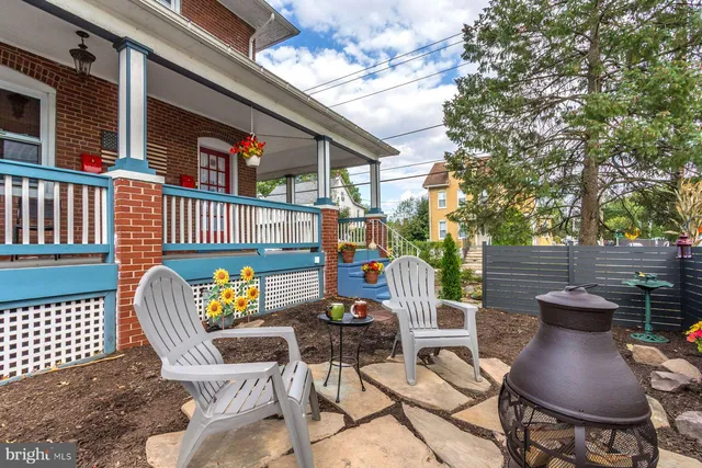 a view of a brick house with many windows and a table