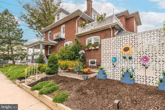 a view of house with wooden deck and furniture