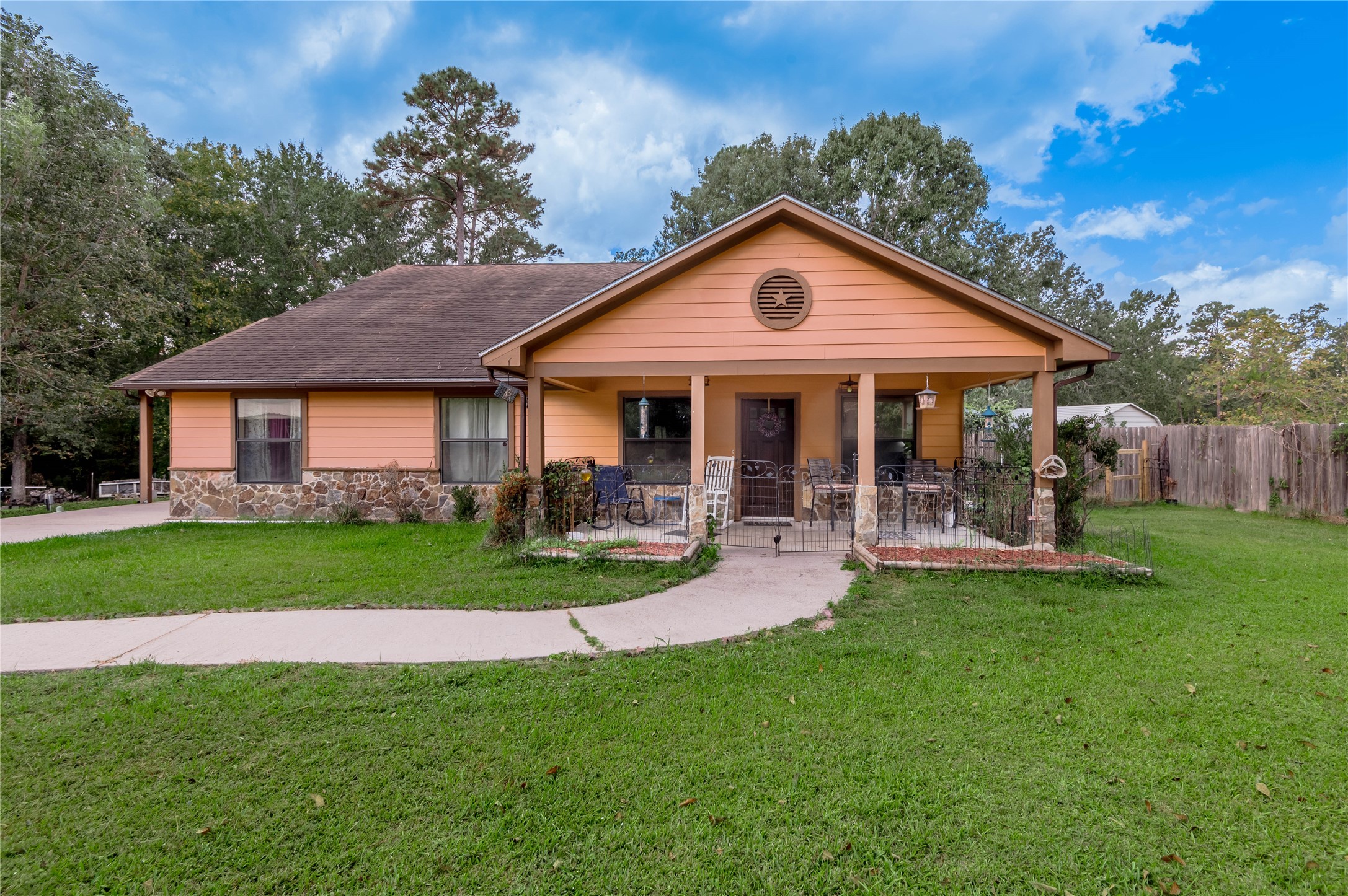 47-57 Stage Coach Road Coldspring, TX 77331 - Photo 1 of 50 a front view of a house with a yard table and chairs