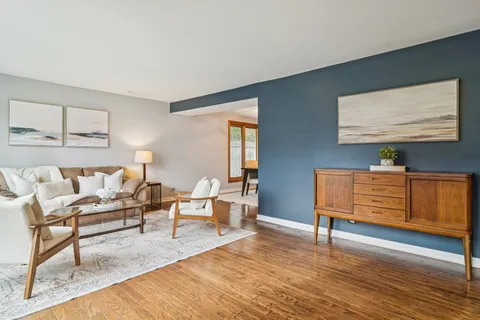 a living room with furniture and wooden floor