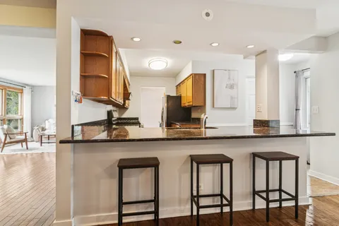 a kitchen with lots of counter space and chairs in it