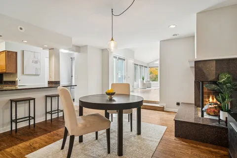 a living room with furniture a table and kitchen view