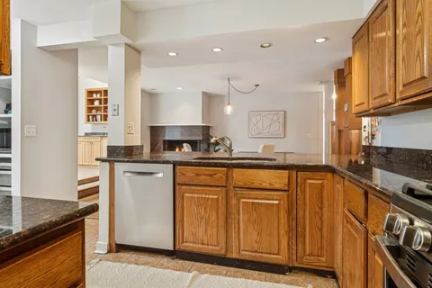 a kitchen with stainless steel appliances granite countertop a stove a sink and a refrigerator