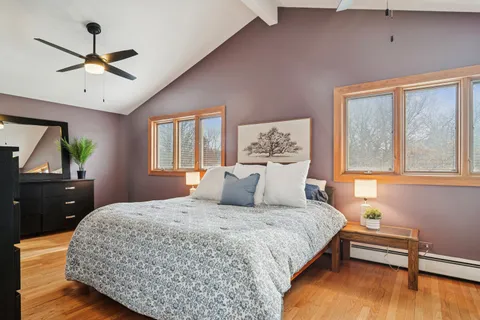 a bedroom with a large bed and a chandelier