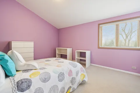 a bedroom with a bed and a table