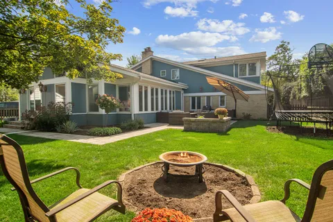 a view of backyard of house with seating space