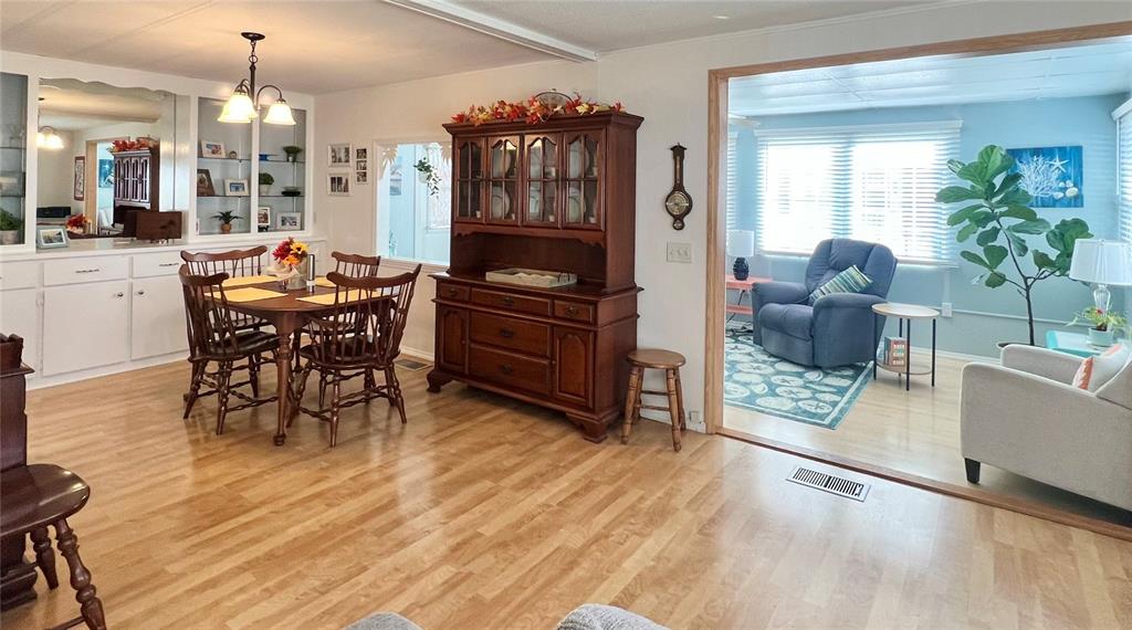 1100 South Belcher Road, Unit 604 Largo, FL 33771 - Photo 19 of 64 a room with furniture a wooden floor and a chandelier