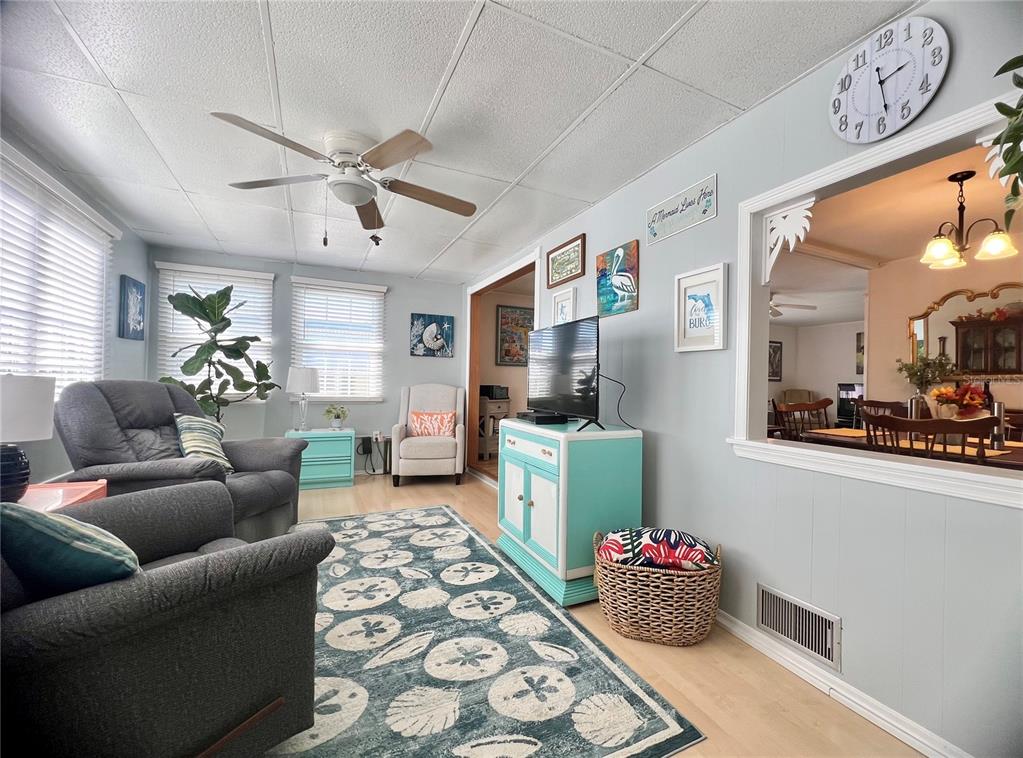 1100 South Belcher Road, Unit 604 Largo, FL 33771 - Photo 20 of 64 a living room with furniture and a chandelier