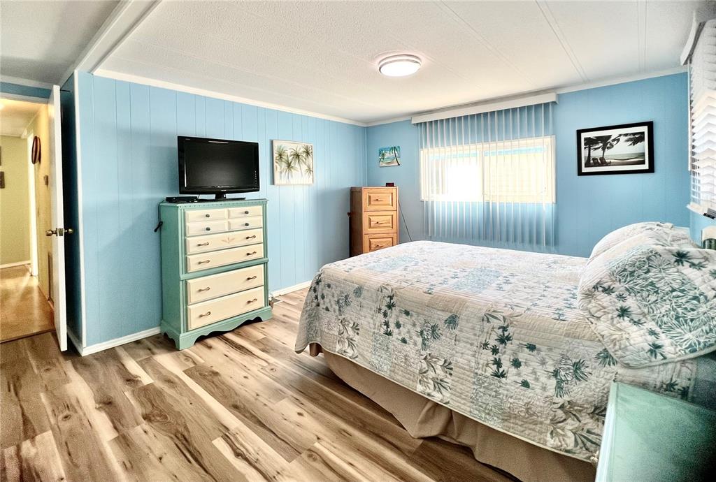 1100 South Belcher Road, Unit 604 Largo, FL 33771 - Photo 26 of 64 a bedroom with a bed and a flat screen tv