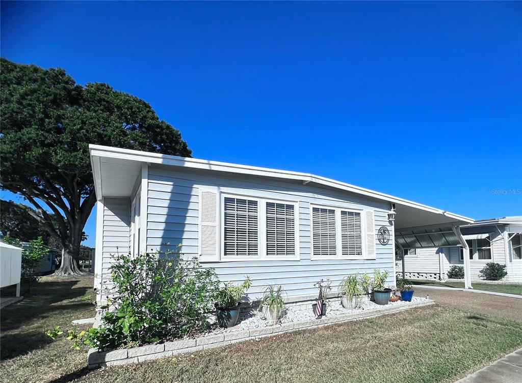 1100 South Belcher Road, Unit 604 Largo, FL 33771 - Photo 4 of 64 a front view of a house with a yard