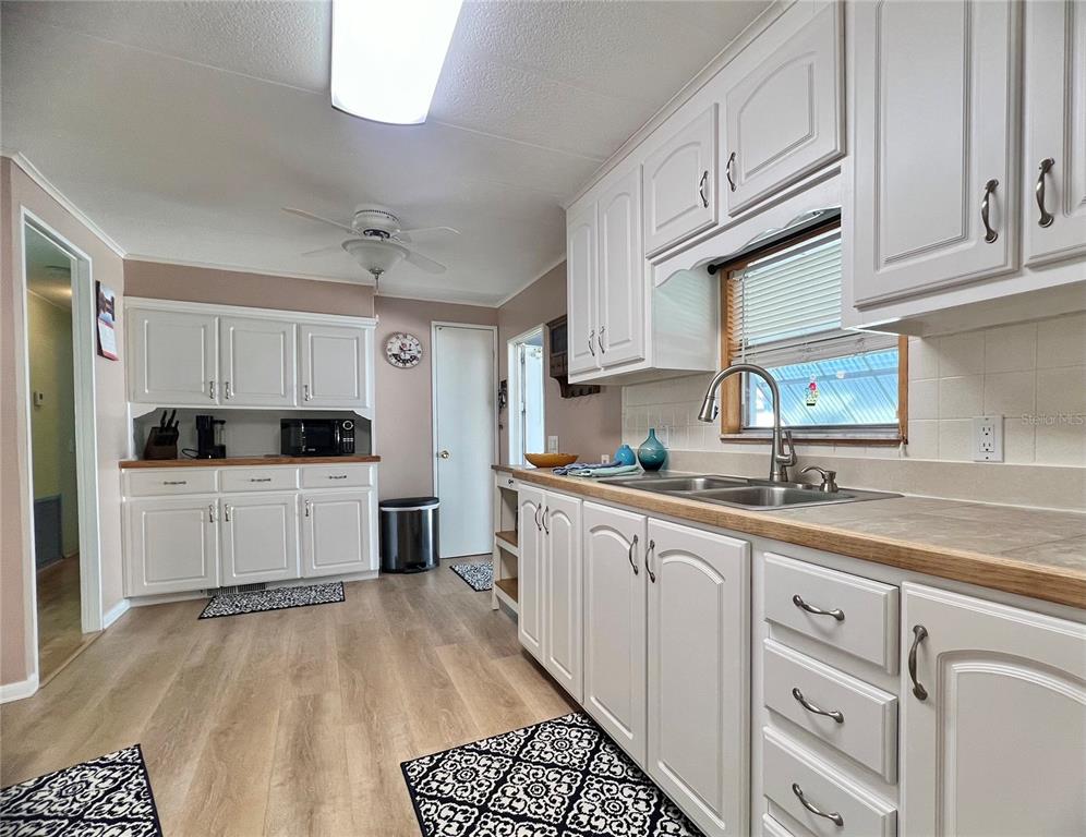 1100 South Belcher Road, Unit 604 Largo, FL 33771 - Photo 9 of 64 a kitchen with granite countertop white cabinets and white appliances