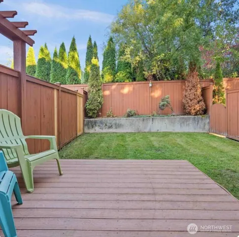 a view of a backyard with wooden fence