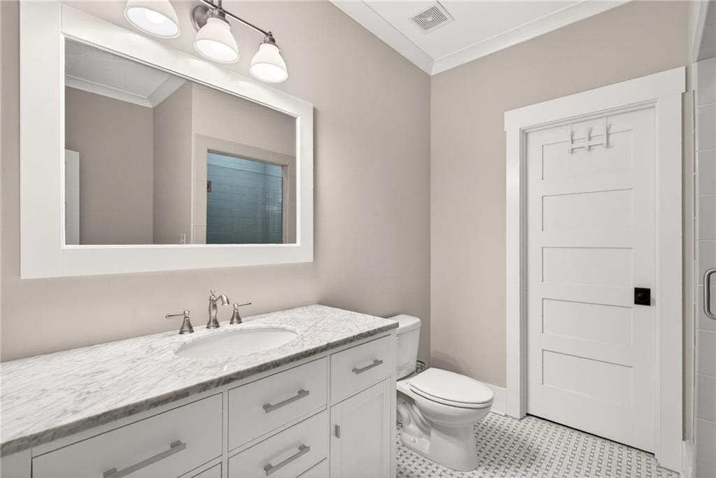 13460 New Providence Road Milton, GA 30004 - Photo 28 of 60 a bathroom with a granite countertop toilet sink and mirror