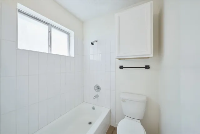 a white toilet sitting next to a bathroom sink