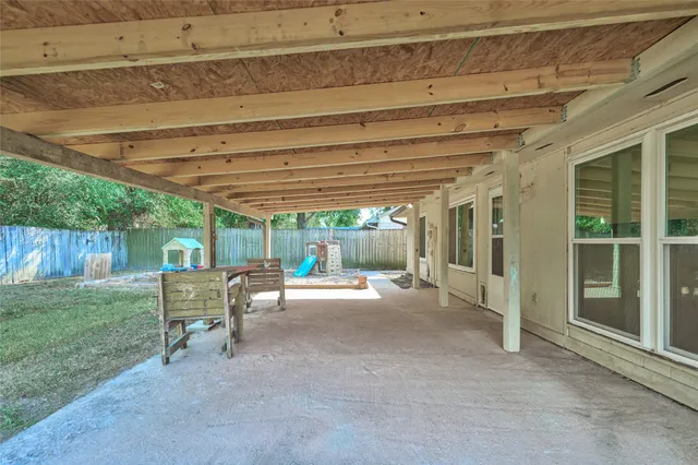 a view of a backyard with table and chairs and a barbeque