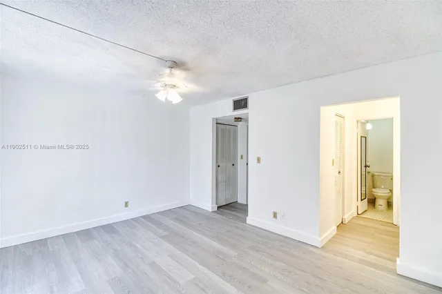 a view of a room with wooden floor
