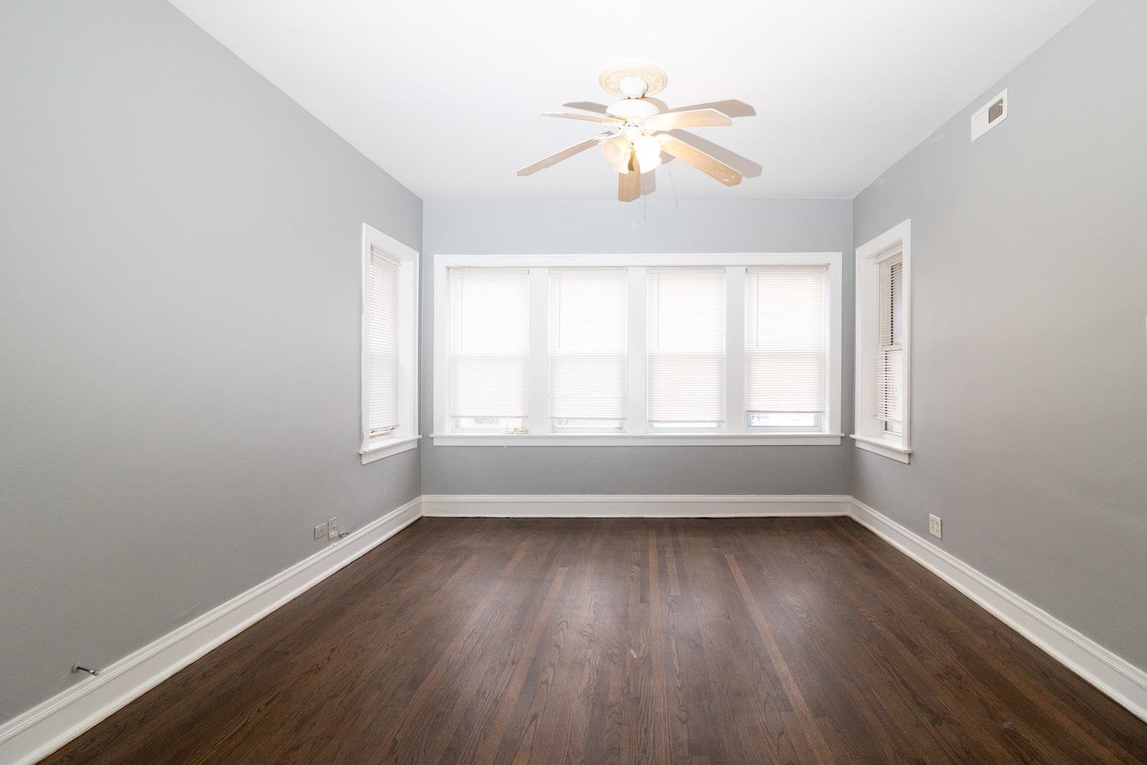 2115 Wesley Avenue, Unit 1 Berwyn, IL 60402 - Photo 4 of 8 an empty room with wooden floor and windows