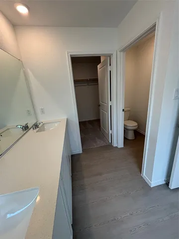 a bathroom with a tub shower vanity and a sink